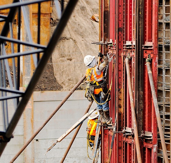 Two workers tied off working on tank at Madison valley stormwater project