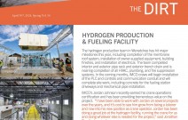 Concrete hydrogen facility, white enclosure on blue compressors