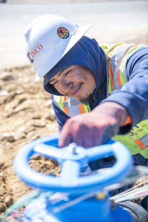 East Kuna Off-Site Infrastructure Project - IMCO Construction Man in hard hat turning blue metal wheel