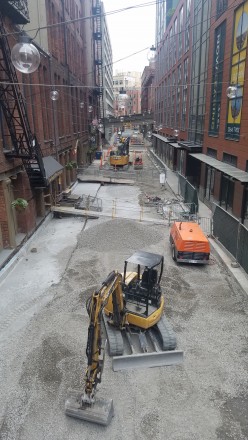 A look at construction being done on the narrow Post Avenue lined by historic buildings IMCO Construction performing street repair on Post Avenue for the City of Seattle