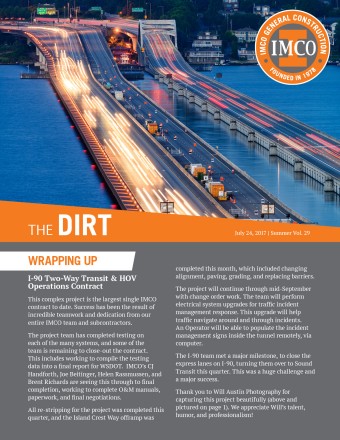 The Dirt newsletter cover with round IMCO logo and orange heading box, I-90 roadway with dramatic lighting and floating bridge