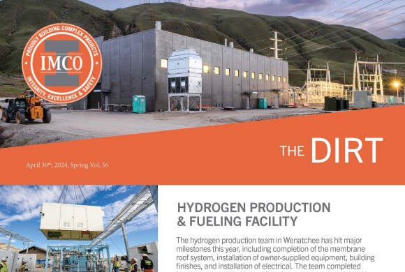 Hydrogen Production and Fueling Facility - IMCO Construction Concrete Hydrogen facility enclosed in fencing at night with power lines