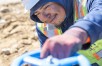 Man in hard hat turning blue metal wheel