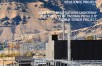 Construction workers at hydrogen facility at the base of dirt hills.