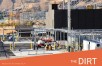 Concrete hydrogen facility, white enclosure on blue compressors