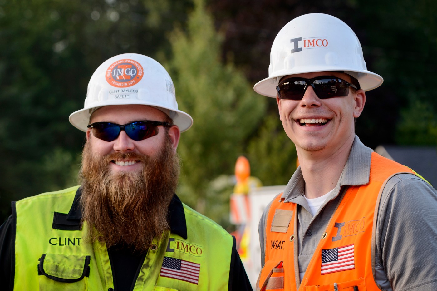 Two men smiling on a construction site