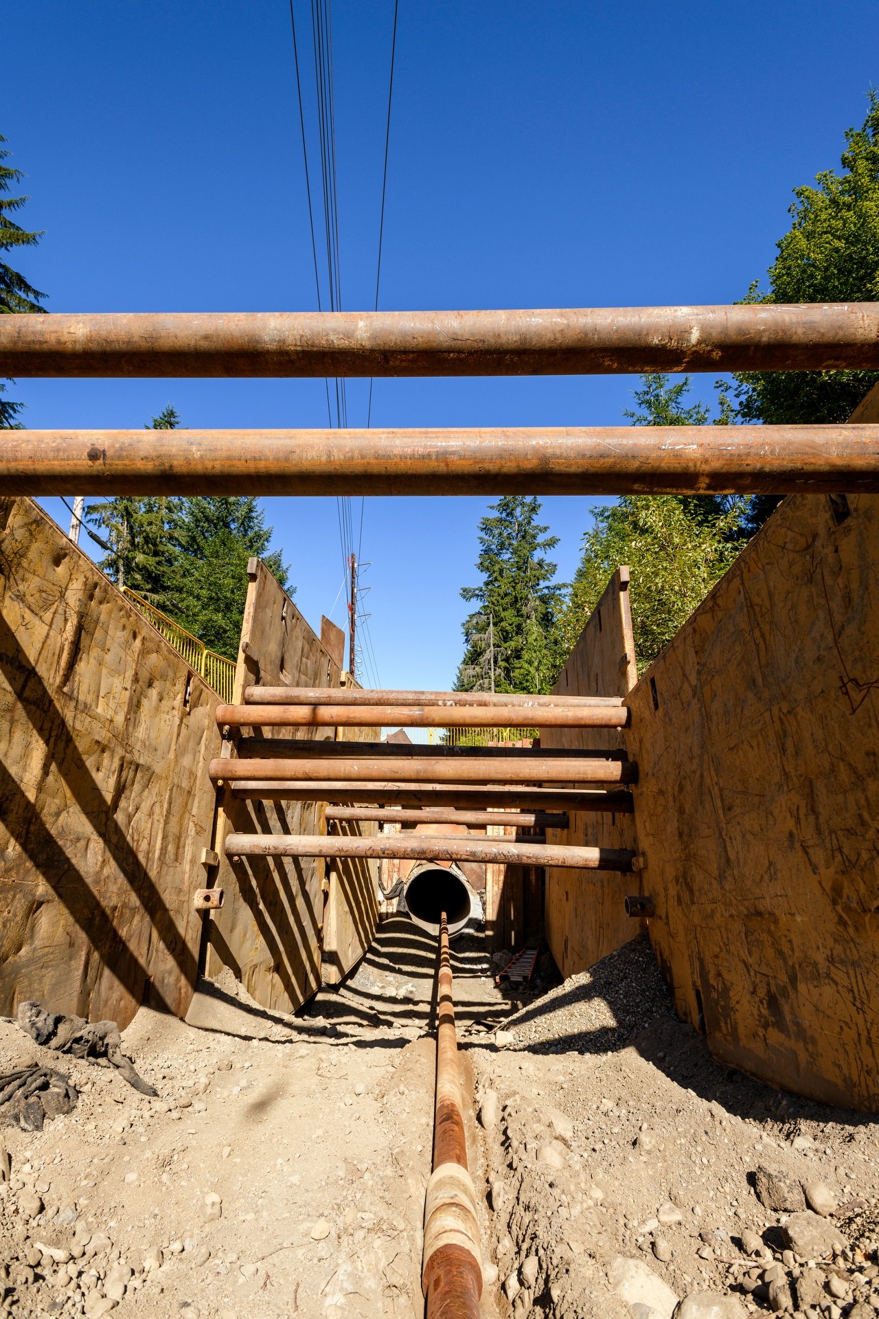 pipe heading up through trench to blue sky