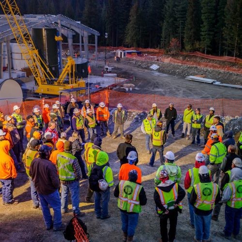 Group of people gathered in circle on construction site