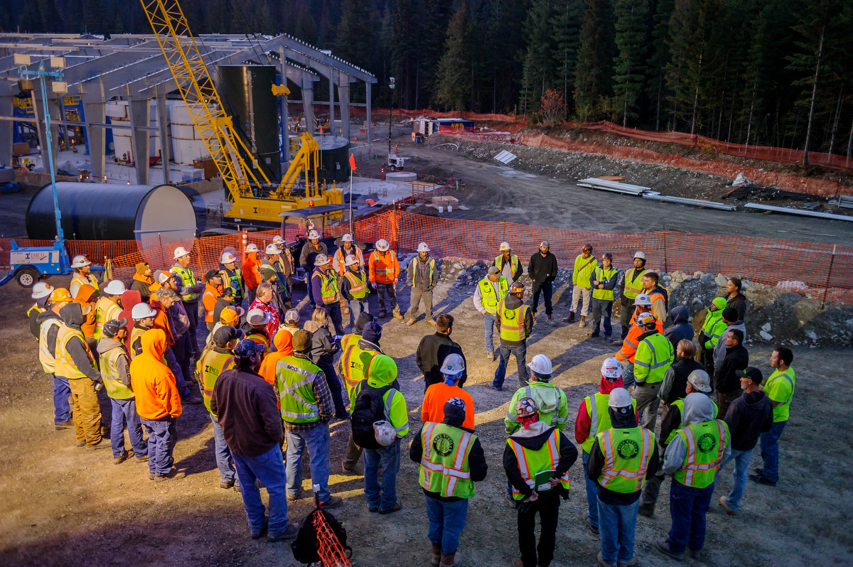 Group of people gathered in circle on construction site