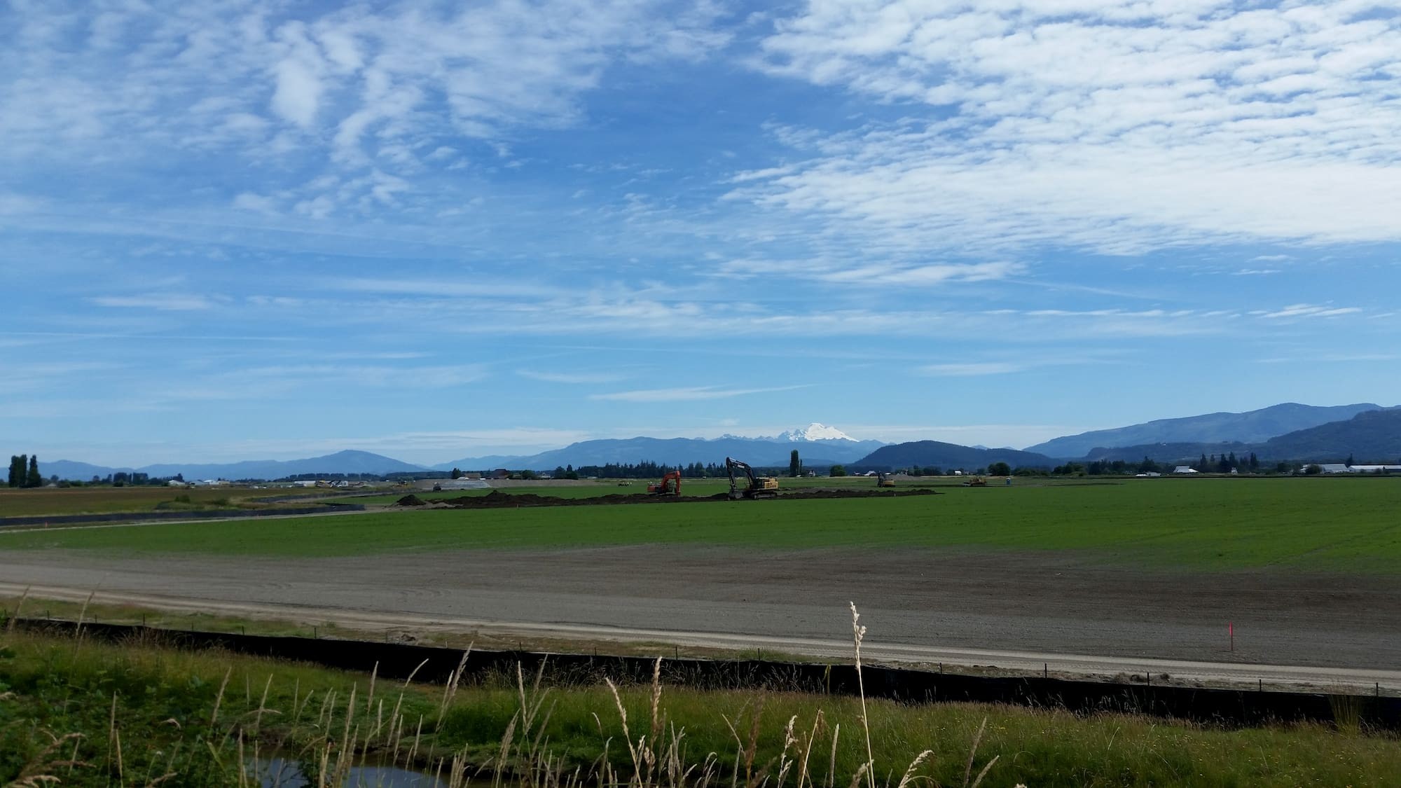 Excavators in Fresh Grass Fir Island Restoration Project