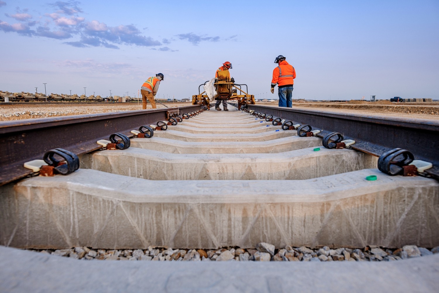Orchard Combat Rail Addition construction workers on rail addition at dusk