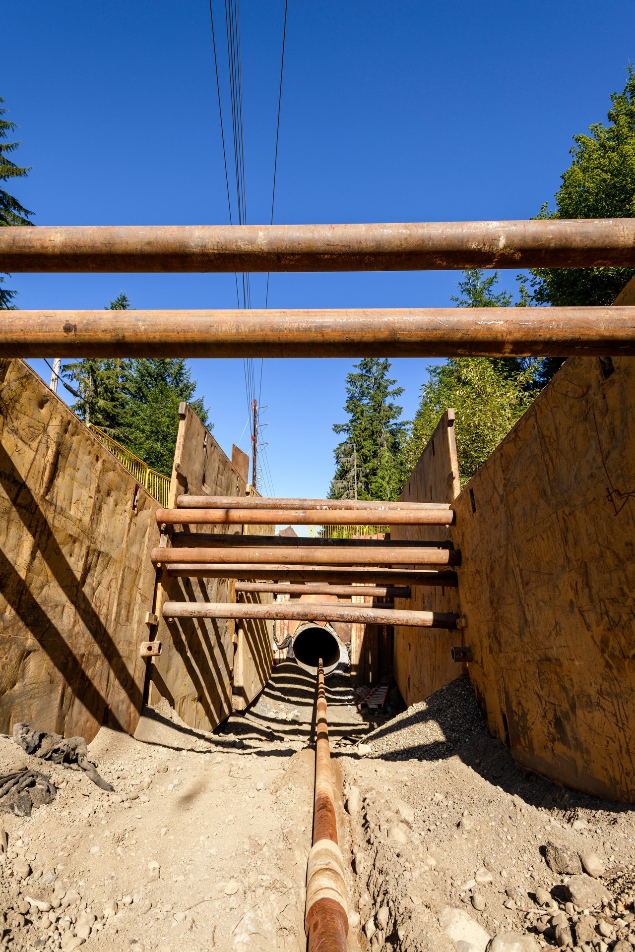 Tolt Pipeline pipe heading up through trench to blue sky