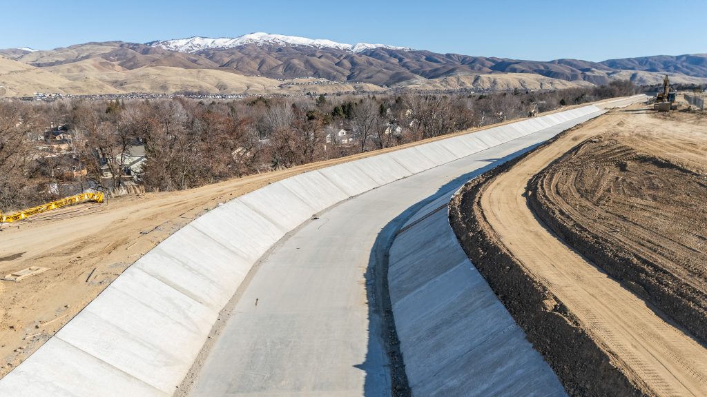 paved canal winding through hillside